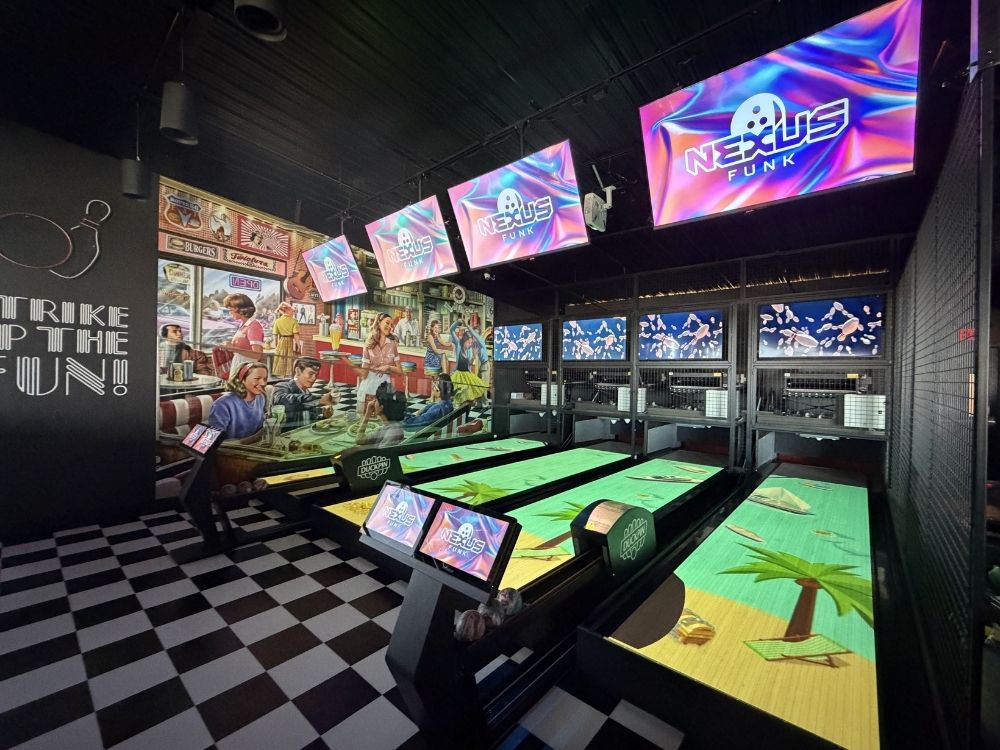 Duckpin bowling alley equipment with Nexus scoring and immersive on-lane projection installed at Tastyland Monroeville, featuring four interactive bowling lanes.